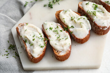 Pieces of fresh bread with lard spread on white background