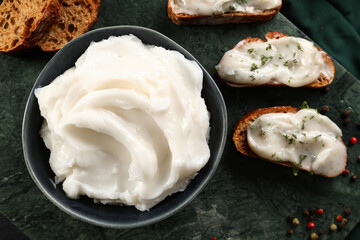 Bowl of lard spread and bread on table