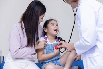 Doctor hold stethoscope exam little girl patient visit doctor with mother, Doctor check heart lungs of kid do pediatric checkup in hospital.