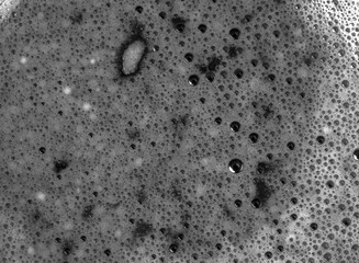 The texture of coffee with closeup bubbles in black and white