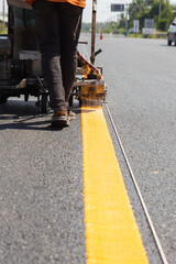 Machine eject and worker on road and traffic sign painting