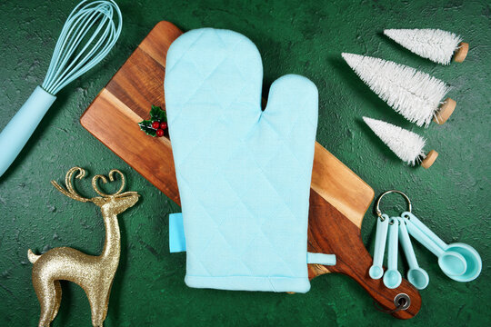 Oven glove product mockup. Christmas theme SVG craft product mockup styled with gift with buffalo plaid bow and farmhouse style gnomes against a green background.