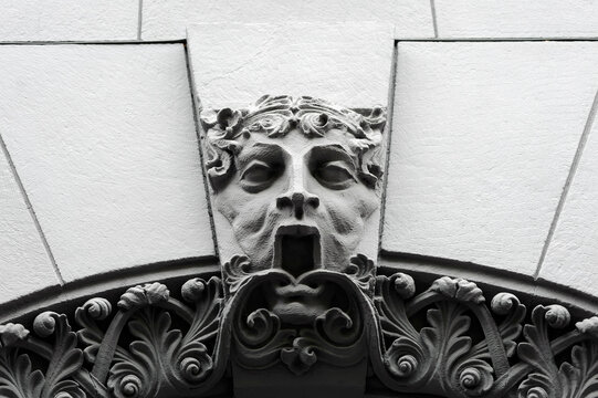 Mascaron with open mouth on old building facade in Kyiv Ukraine