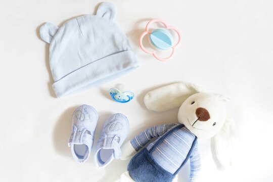 Newborn baby clothing and rabbit toy on white background,Top view, flat lay.