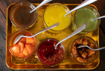 Top view of various Indian seasoning sauces. A seasoning is anything you add to your food to enhance the flavor.