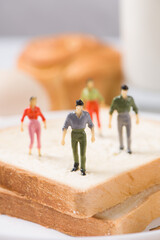 miniature people standing on sliced bread (work on bread)