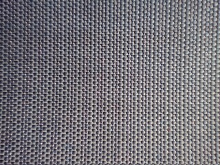 Closeup black plastic mat background texture with intertwined bands
