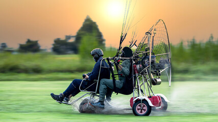 Two men flying and gliding in the air, Flying on paramotor, Preparation for flights on paramotors,...