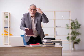 Aged male teacher in the classroom