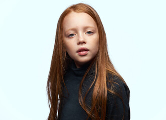 red-haired girl in a black sweater planning close-up