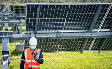 The technician takes the Thermoscan(thermal image camera) scan to the solar panel to check the hot spots in the cell, Concept to use technology to check the damage in the Solar plant