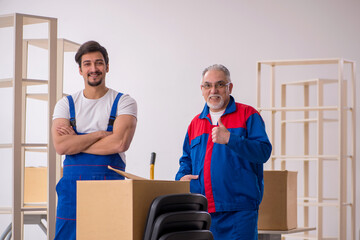 Two male professional movers doing home relocation