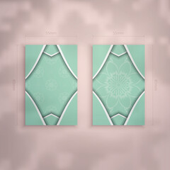 Mint color business card with luxurious white ornaments for your brand.
