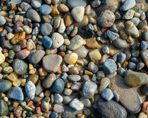 Pebbles of different colors, shapes, and textures on a beach