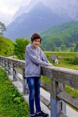 happy boy smiling at camera in julian alps, slovenia
