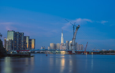 Fototapeta na wymiar skyline with landmark 81 skyscraper, a new cable-stayed bridge is building connecting Thu Thiem peninsula and District 1 across the Saigon River.