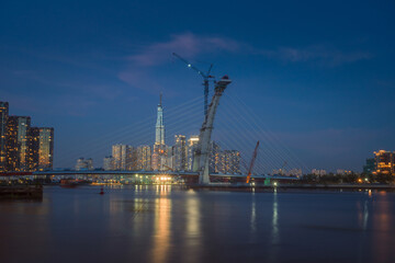 Naklejka premium skyline with landmark 81 skyscraper, a new cable-stayed bridge is building connecting Thu Thiem peninsula and District 1 across the Saigon River.