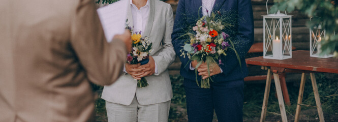 Lesbian brides holding wedding bouquets - 466634051