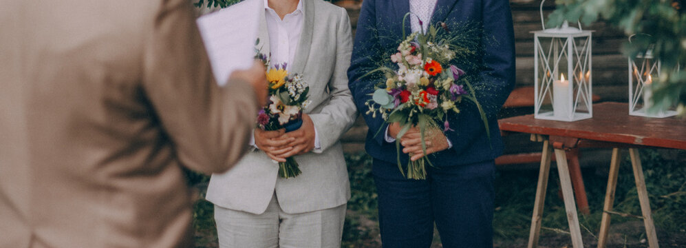 Lesbian brides holding wedding bouquets