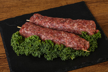 Raw minced beef kebab skewer
