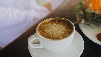 Woman drinking tasty beverages coffee Cappuccino Latte Art. Traveler spending time in traditional local floating cafe on water. Attractive blonde girl having breakfast outdoor. Tropical view