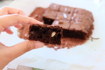 Slices of homemade brownie, selective focus.  Pieces of brownies on wooden table. Chocolate cakes with walnuts. It is called 