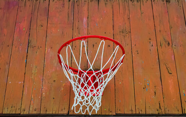 Basketball hoop with a net on a wooden backboard. Basketball game. Throw the ball. Team play. Street sports. Rest and leisure. Sports ground. Healthy lifestyle. Background image. © malaha
