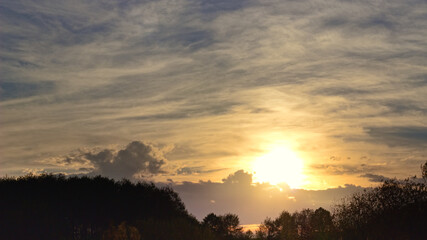 Landscape with autumn sunset and clouds.