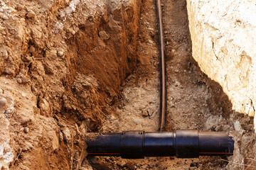 Plastic pipe is laid in a trench