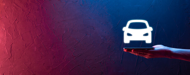 Male hand holding car auto icon on neon red,blue background. Wide banner composition.Car automobile...