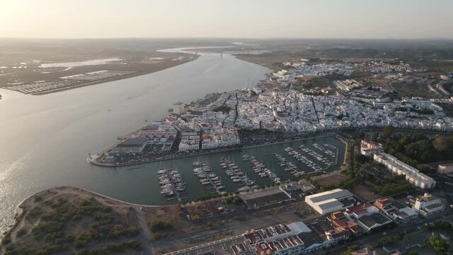 Aerial forward view of coastal town of Ayamonte with its marina. Andalusia, Spain.