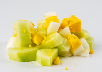 diced cucumber and egg on white background. Traditional Russian Moscow salad. Olivier in a white bowl on a white background. 