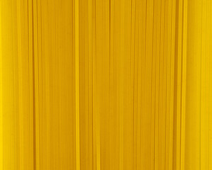 Obraz premium Uncooked spaghetti close-up background. Top view. Pasta. Background image of pasta from durum wheat.
