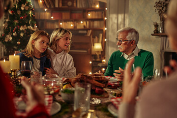 Cheerful family having lunch together on Christmas eve at home