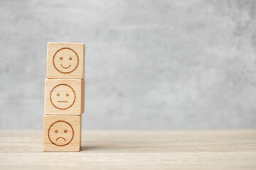 emotion face symbol on wooden blocks. mood, Service rating, ranking, customer review, satisfaction, evaluation and feedback concept