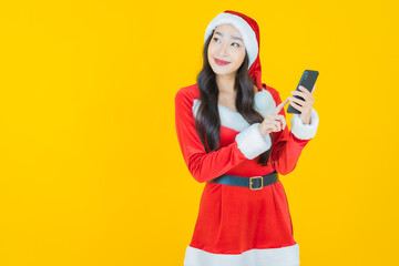 Portrait young asian woman wear christmas costume with action on yellow background
