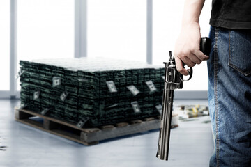 Criminal man holding the gun while robbery the money