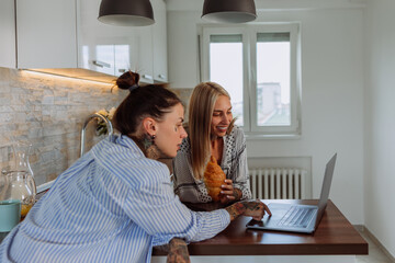 Two lesbians using laptop