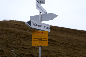 Sign post at fighter shooting range of Swiss Air Force at Axalp, Canton Bern, on a grey and cloudy autumn day. Photo taken October 19th, 2021, Brienz, Switzerland.