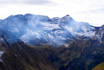 Mountain panorama with fresh snow seen from Axalp at Bernese Highlands on a grey cloudy autumn day. Photo taken October 19th, 2021, Brienz, Switzerland.
