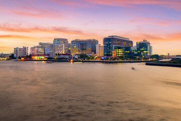 Naklejka premium Public hospital, Faculty of Medicine Siriraj Hospital at twilight time in the Chao Phraya River, Bangkok