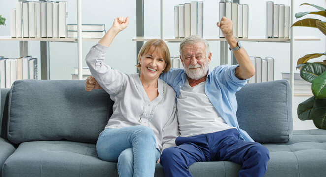 Caucasian old senior grandparents couple in casual wear gray bearded and hair husband and grandma wife sitting shouting smilingsatisfying cheering sport winning victory with excited action