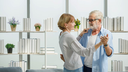 Caucasian old senior elderly happy grandparents lover married couple standing smiling listening to...