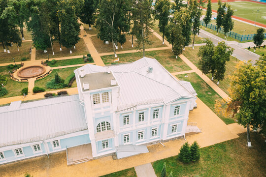 Aerial View Old Ttwo-storey House Manor Built In Early 20th Century Of Hereditary Honorary Citizen, Merchant Andrey Avraamov. Drone View Of City Park Of Culture And Recreation In Summer Season. Bird's