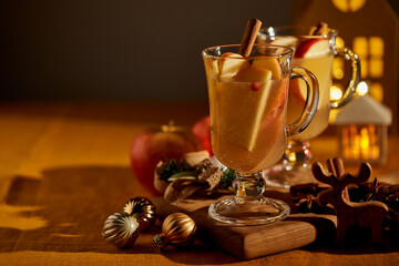 Two glasses of hot christmas winter apple gluhwein. Alcohol white mulled wine with cinnamon,...