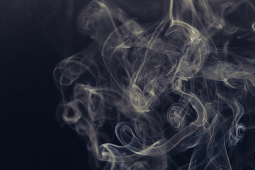 White smoke in front of the black background.	
