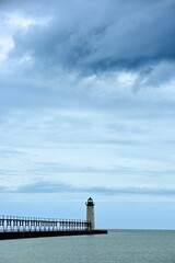 the historic manistee north pierhead lighthouse on fifth avenue beach on eastern lake michigan, michigan, with its elevated  walkway, on a stormy day