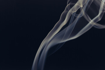 White smoke in front of the black background.	
