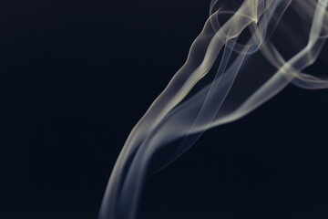 Fototapeta premium White smoke in front of the black background. 
