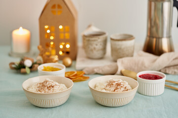 Christmas food. Rice pudding. French milk rice dessert. Pastel cozy atmosphere morning holiday breakfast or evening lunch. Linen textile on table in kitchen or living room at home with Christmas decor